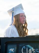 Palmerton graduate, Kayla Cincilla pokes her head out of a Jeep during Palmerton’s graduation ceremony at Pocono Raceway.