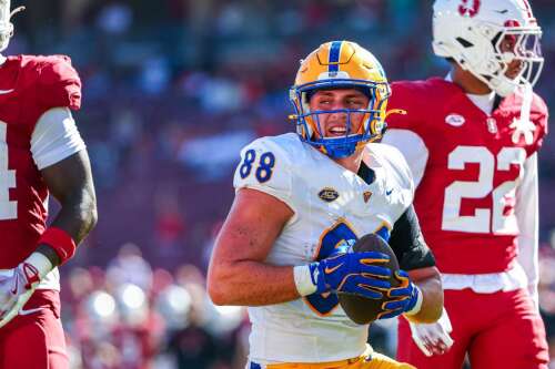 Holmes caps career with 100-yard game