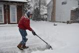 Dean Fisher of 235 S. Fourth St. cleans the snow from his pavements early Monday morning. TERRY AHNER/TIMES NEWS