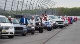 Students from the Jim Thorpe class of 2020 line up next to their vehicles for a group photo on the track at Pocono Raceway before their graduation ceremony.
