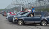 Family and faculty line the track for a front-row view of the graduation festivities at Pocono Raceway.