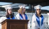 Class Valedictorian Grace Costenbader, Salutatorian Erica Messics and other Salutatorian Mikayla Wilkins stand on the podium to deliver their combined speech.